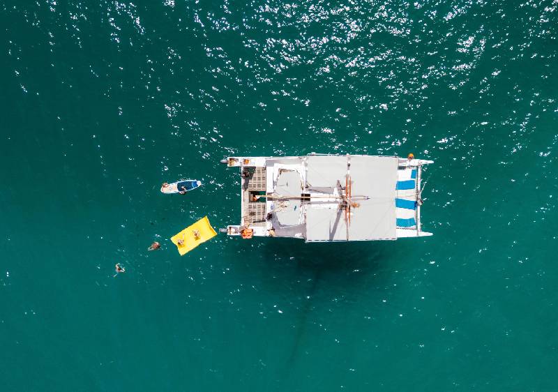 Couple watching Cabo San Lucas sunset from private catamaran