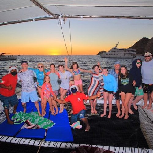 friends-toasting-on-catamaran-cabo-private-sunset