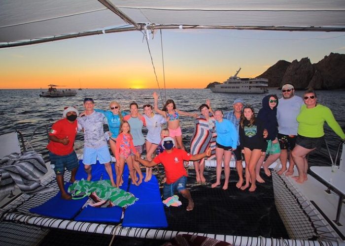friends-toasting-on-catamaran-cabo-private-sunset